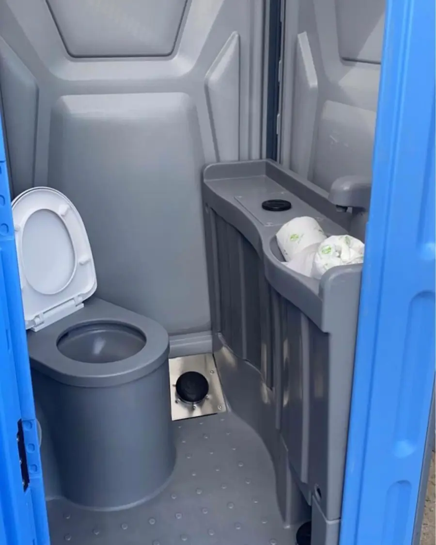 Deluxe unit interior with toilet seat and a sink counter