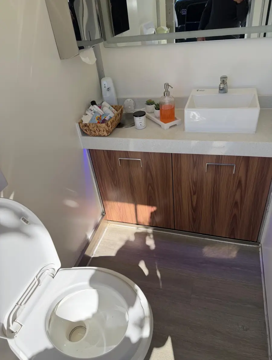 Vanity sink, mirror and soap inside a restroom trailer