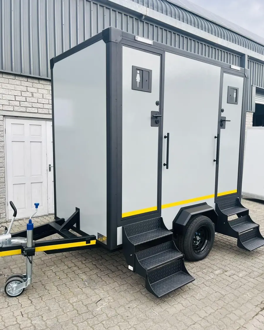 Two-stall restroom trailer with steps to each door